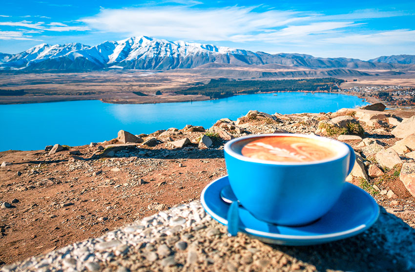 A cup of coffee on the background of snowy mountains