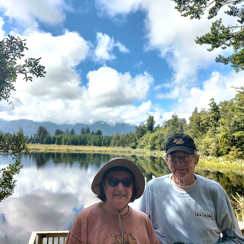 Customers of The Road Trip New Zealand with a lake and mountains in the background