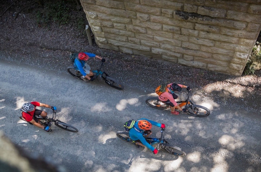 4 people biking from above 