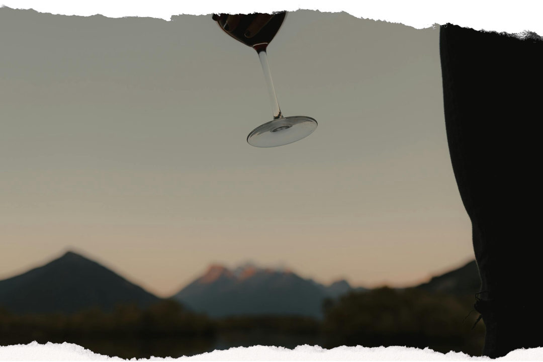Guest enjoying a glass of wine with lake and mountain views in Glenorchy
