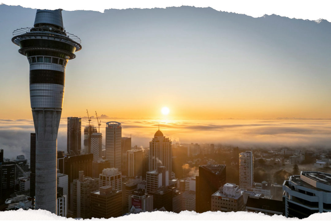 Auckland skyline at sunrise through soft morning fog