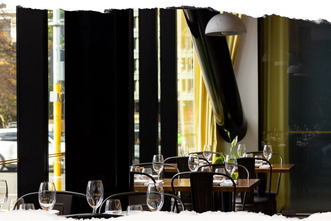 The dining room at Inati in central Christchurch, with timber tables, bentwood chairs and dome pendant lights